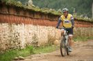 Cycling past mani wall in the Paro Valley