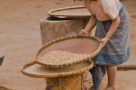 Local girl preparing grain