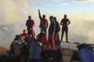 Porters in the Kori Sunrise. Image by N Morgan