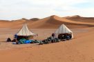 Setting up camp among the sand dunes